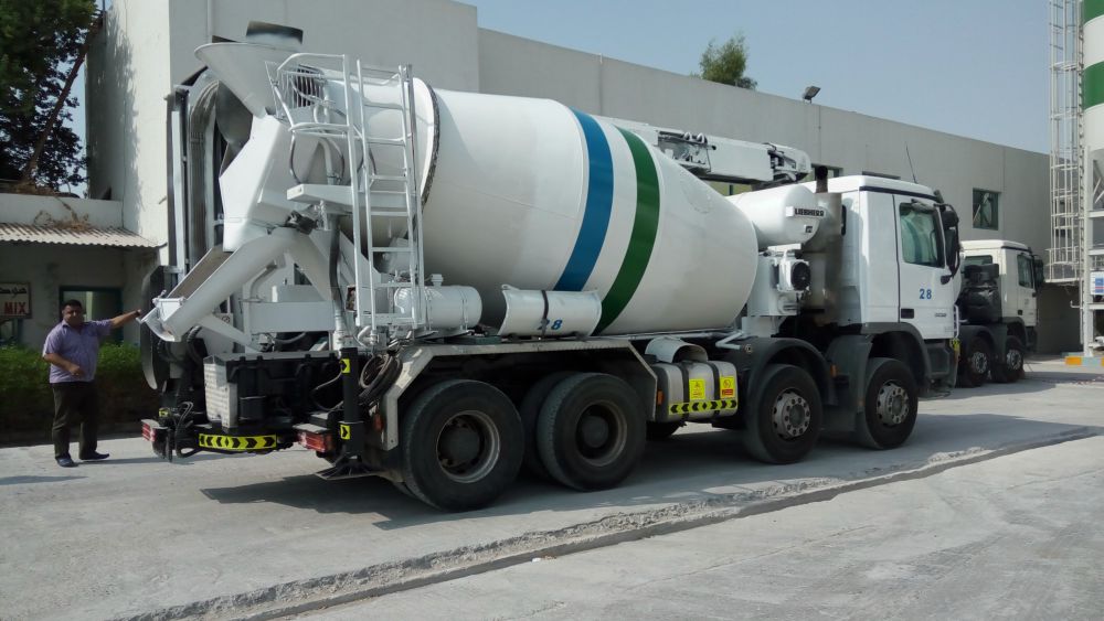 Modern Mix truck mixer number 28 with discharge chute extended at the plant